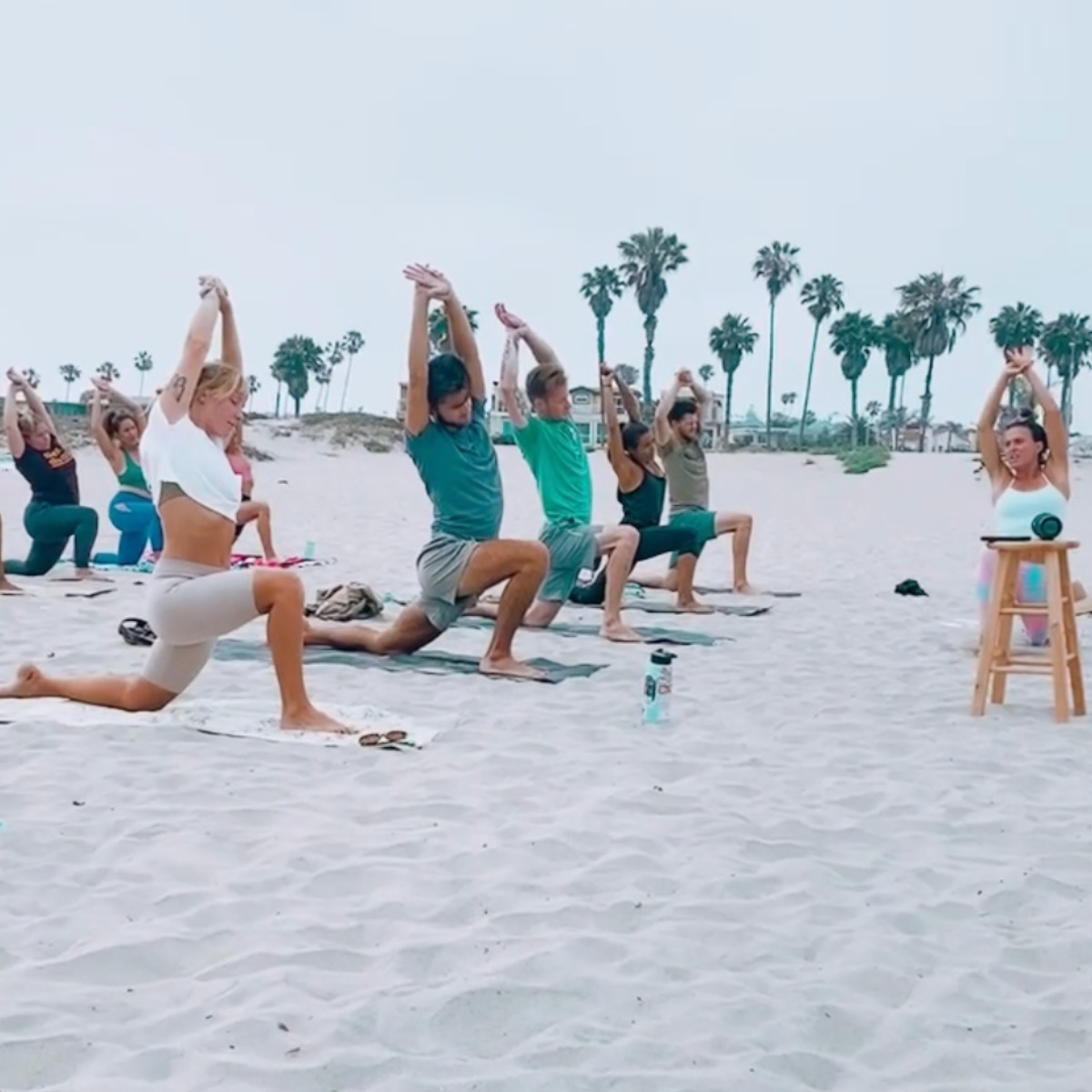 People doing Yoga on the beach