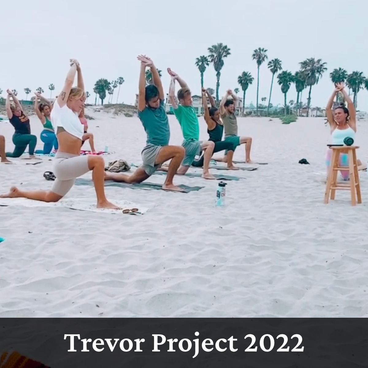 Group of people doing Yoga on the beach